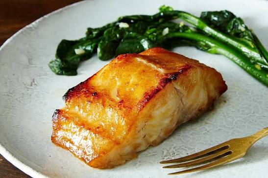 Glazed black cod fillet with sautéed greens